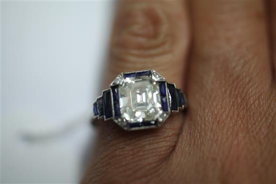 An Art Deco platinum single stone diamond and sapphire octagonal dress ring, size M.
